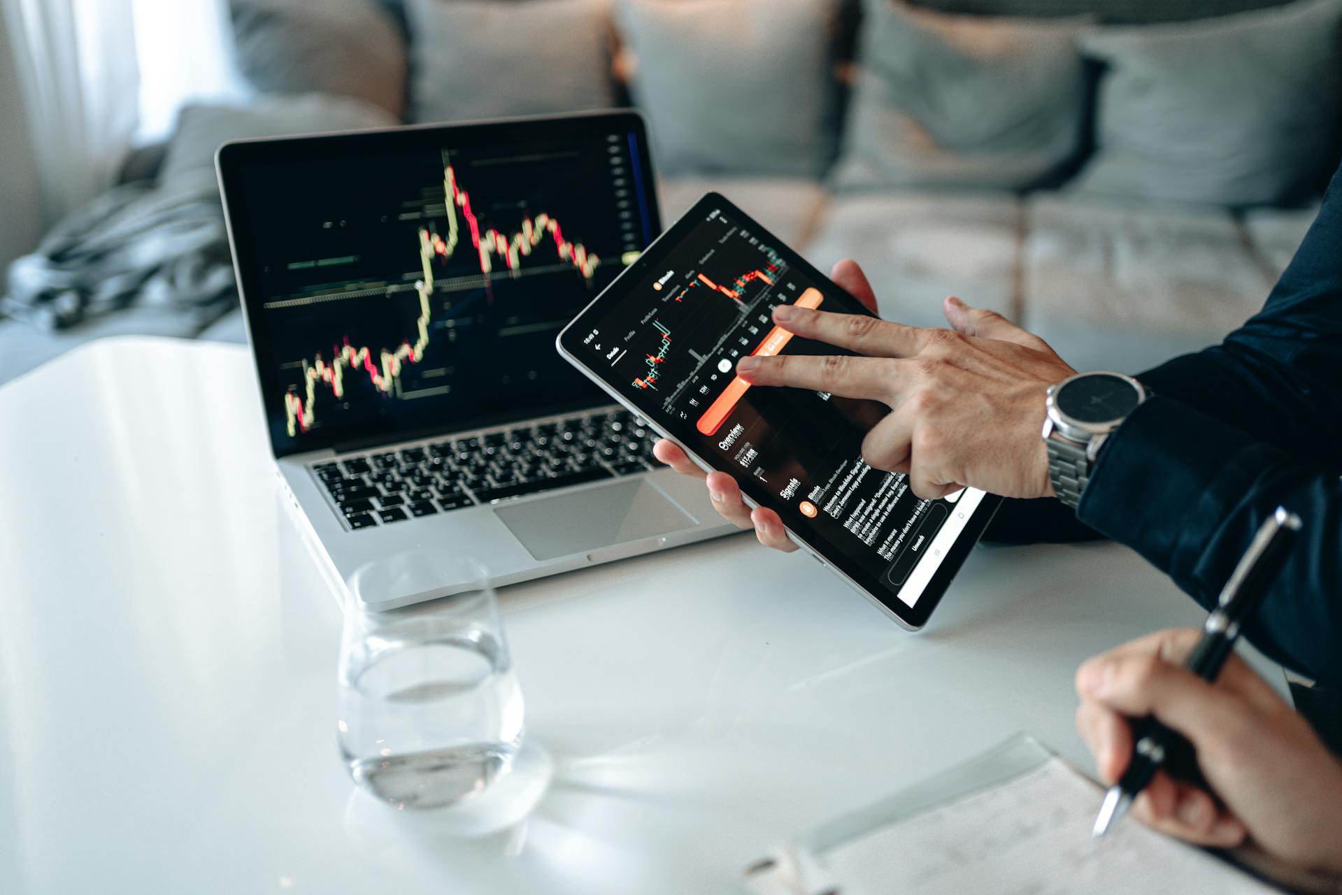 Laptop screen displaying market graphs and financial charts.